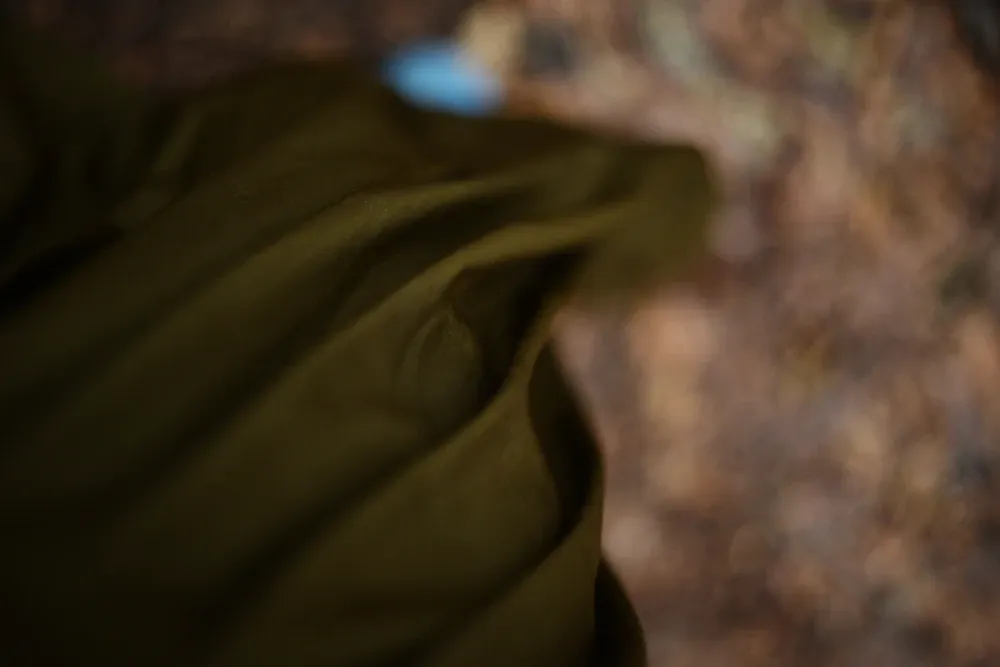 Dark cloth falling in deep folds, caught against shadow.